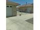 View of an extra-long driveway and detached garage with chain-link fencing at 1611 Red Rock Dr, Pahrump, NV 89048