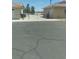 Large asphalt driveway leading to a gated backyard and detached garage at 1611 Red Rock Dr, Pahrump, NV 89048