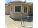 Exterior view of a stucco home with bay windows and a fenced-in backyard at 1611 Red Rock Dr, Pahrump, NV 89048