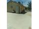 View of the exterior of an outbuilding, including storage, and gated access at 1611 Red Rock Dr, Pahrump, NV 89048
