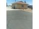 View of the exterior of an outbuilding including gated access and an asphalt driveway at 1611 Red Rock Dr, Pahrump, NV 89048