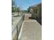 Side yard is enclosed with gravel and a stone paver walkway at 1611 Red Rock Dr, Pahrump, NV 89048
