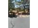 Xeriscaped front yard with scattered bushes, shrubs, and mature trees at 1611 Red Rock Dr, Pahrump, NV 89048