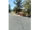 Well-maintained yard with mature trees and some xeriscaping at 1611 Red Rock Dr, Pahrump, NV 89048