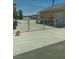 View of the exterior of the property with a fenced area and concrete driveway at 1611 Red Rock Dr, Pahrump, NV 89048