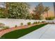 Backyard featuring a green lawn, patio, landscaping, and privacy wall at 1616 Shadow Rock Dr, Las Vegas, NV 89117