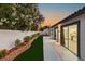 Backyard with patio, landscape and sliding glass doors to the home's interior at 1616 Shadow Rock Dr, Las Vegas, NV 89117