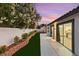 Backyard featuring a concrete patio, privacy wall with beautiful flowers and direct access to kitchen at 1616 Shadow Rock Dr, Las Vegas, NV 89117