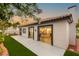 Backyard with covered patio, green lawn, and lush landscaping at 1616 Shadow Rock Dr, Las Vegas, NV 89117