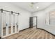 Bright bedroom with modern barn doors, wood floors, and lots of light at 1616 Shadow Rock Dr, Las Vegas, NV 89117