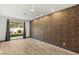 Bright bedroom with wood floors, neutral wall, and large window view of landscaped yard at 1616 Shadow Rock Dr, Las Vegas, NV 89117