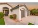 Home exterior showcasing front entrance, two car garage, desert landscaping at 1616 Shadow Rock Dr, Las Vegas, NV 89117