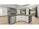 Modern eat-in kitchen with stone countertop island, stainless appliances, and view of the backyard at 1616 Shadow Rock Dr, Las Vegas, NV 89117