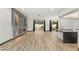 Open floor plan showing living area with wood-look flooring, decorative fireplace and view to backyard at 1616 Shadow Rock Dr, Las Vegas, NV 89117
