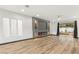 Spacious living room featuring wood-look floors, decorative fireplace, and backyard access at 1616 Shadow Rock Dr, Las Vegas, NV 89117