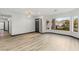 Bright living room featuring wood-look flooring, a large bay window with view, and neutral paint at 1616 Shadow Rock Dr, Las Vegas, NV 89117