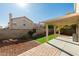 Secluded backyard boasts low-maintenance landscaping, covered patio, and plenty of space for entertaining at 1917 Badger Canyon Ave, North Las Vegas, NV 89031