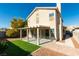 Charming backyard with manicured lawn, covered patio, and mature landscaping, perfect for outdoor enjoyment at 1917 Badger Canyon Ave, North Las Vegas, NV 89031