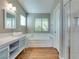 Light-filled bathroom featuring a soaking tub, separate shower, and stylish vanity with double sinks at 1917 Badger Canyon Ave, North Las Vegas, NV 89031