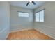 Neutral bedroom featuring hardwood floor and natural light from two windows at 1917 Badger Canyon Ave, North Las Vegas, NV 89031