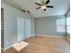 Bedroom featuring hardwood floor, ceiling fan and large closet with windows at 1917 Badger Canyon Ave, North Las Vegas, NV 89031