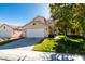 Charming two-story home featuring a well-manicured front yard and attached two-car garage at 1917 Badger Canyon Ave, North Las Vegas, NV 89031