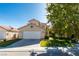 Charming two-story home featuring a well-manicured front yard and attached two-car garage at 1917 Badger Canyon Ave, North Las Vegas, NV 89031