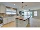 Bright, updated kitchen with an island, stainless appliances, mosaic backsplash, and slider to the yard at 1917 Badger Canyon Ave, North Las Vegas, NV 89031