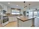 Beautiful kitchen featuring stainless steel appliances, stylish lighting, and backyard access at 1917 Badger Canyon Ave, North Las Vegas, NV 89031