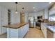 Updated kitchen features stainless appliances, a kitchen island with butcher block, and stylish pendant lighting at 1917 Badger Canyon Ave, North Las Vegas, NV 89031