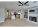 Open-concept kitchen and living area with fireplace, tile flooring, and island at 1917 Badger Canyon Ave, North Las Vegas, NV 89031