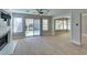Spacious living room featuring tile flooring, a ceiling fan, and access to the backyard at 1917 Badger Canyon Ave, North Las Vegas, NV 89031