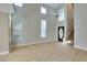 Spacious living room featuring tile floors, high ceilings, and large windows for plenty of natural light at 1917 Badger Canyon Ave, North Las Vegas, NV 89031