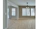 Sunlit living space with neutral walls, large windows, and tiled floor at 1917 Badger Canyon Ave, North Las Vegas, NV 89031