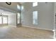 Spacious living room featuring tile floors, high ceilings, and large windows for plenty of natural light at 1917 Badger Canyon Ave, North Las Vegas, NV 89031
