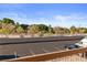 Balcony with view of community landscaping and parking, under blue sky at 1928 Las Palmas Ln # 228, Laughlin, NV 89029