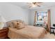 Inviting bedroom featuring a comfortable bed, a window with curtains, and a ceiling fan for added comfort at 1928 Las Palmas Ln # 228, Laughlin, NV 89029