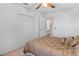 Bedroom featuring a comfortable bed with decorative pillows, a closet, and a glimpse into an ensuite bathroom at 1928 Las Palmas Ln # 228, Laughlin, NV 89029