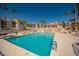 A clear shot of the community pool and common areas with palm trees and lounge chairs for residents at 1928 Las Palmas Ln # 228, Laughlin, NV 89029