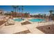 Inviting community pools with lounge chairs, desert landscaping and common seating area at 1928 Las Palmas Ln # 228, Laughlin, NV 89029