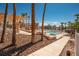 Inviting community pool area with desert landscaping and covered seating areas with community condos in the background at 1928 Las Palmas Ln # 228, Laughlin, NV 89029