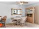 Comfortable dining room featuring a round table with seating for four, a ceiling fan, and a cabinet at 1928 Las Palmas Ln # 228, Laughlin, NV 89029