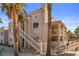 Charming condo building featuring a stucco exterior, red tile roof and lush palm trees at 1928 Las Palmas Ln # 228, Laughlin, NV 89029
