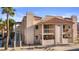 Exterior of condo featuring stucco siding, red tile roof, balconies, and desert landscaping at 1928 Las Palmas Ln # 228, Laughlin, NV 89029