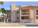 Exterior showcasing balconies, stair access, and meticulous landscaping with a neutral color scheme at 1928 Las Palmas Ln # 228, Laughlin, NV 89029