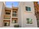 Exterior shot of a two story apartment building with staggered balconies and tropical trees at 1928 Las Palmas Ln # 228, Laughlin, NV 89029