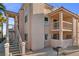 This condo features stucco walls, two balconies, and stairs to entry, creating a comfortable outdoor space at 1928 Las Palmas Ln # 228, Laughlin, NV 89029