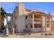 Exterior elevation featuring second-story balconies, desert landscaping, and convenient stair access at 1928 Las Palmas Ln # 228, Laughlin, NV 89029