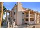 Exterior featuring balconies, direct unit stair access, and desert landscaping at 1928 Las Palmas Ln # 228, Laughlin, NV 89029