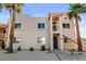 Inviting condo with stucco facade, well-maintained landscaping, and desert surroundings at 1928 Las Palmas Ln # 228, Laughlin, NV 89029